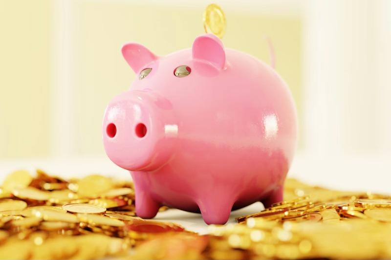 Piggy bank on a pile of gold coins